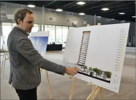  ?? MONIQUE TAMMINGA/The Okanagan Weekend ?? Architect Rob Cesnik shows where the proposed 15-storey tower will go at the Penticton Lakeside Resort during a well-attended open house Thursday.