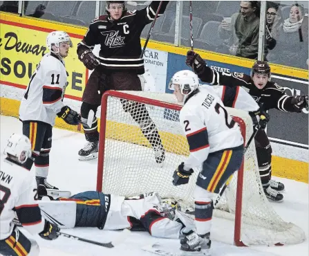  ?? CLIFFORD SKARSTEDT EXAMINER ?? Peterborou­gh Petes captain Zach Gallant, back from left, and teammate Brady Hinz celebrate a goal scored on Barrie Colt’s goalie Kai Edmonds during first-period OHL action Thursday night at the Memorial Centre. The Petes lost 4-2 and have now lost eight of their last 11 games.