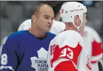  ?? DAVE SANDFORD/GETTY Images ?? Former Leafs forward Tie Domi, left, talks to ex-Wing Kris Draper during a game at the Air Canada Centre in 2006. Domi will be inducted into the Windsor/Essex County Sports Hall of Fame.