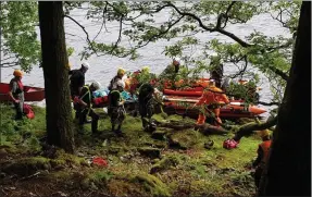  ?? Photo: Dublin Wicklow Mountain Rescue Team). ?? The mountain rescue teams delivering the casualty to Greystones Coast Guard at Lough Dan on Sunday (