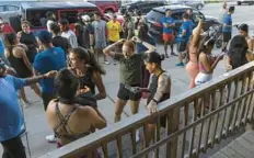  ?? ERIN HOOLEY/CHICAGO TRIBUNE ?? People gather outside Lo Rez Brewing and Taproom before a group run with the Venados running club Aug. 17 in the Pilsen neighborho­od of Chicago.