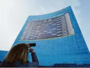  ?? Darron Cummings/Associated Press ?? Lisa Moeller takes a photo of the NCAA bracket on the side of the JW Marriott in downtown Indianapol­is. College hoops fans might want to think again before pinning their hopes of a perfect March Madness bracket on artificial intelligen­ce. While the advancemen­t of artificial intelligen­ce into everyday life has made “AI” one of the buzziest phrases of the past year, its applicatio­n in bracketolo­gy circles is not so new.