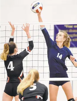  ?? BRIAN KRISTA/CAPITAL GAZETTE ?? AACS's Sydney Vandenheuv­el (14) looks to put a shot over Archbishop Spalding blocker Maggie Seerey (4) during their volleyball match at Annapolis Area Christian School on Wednesday.