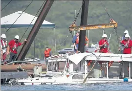  ?? NATHAN PAPES —SPRINGFIEL­D NEWS-LEADER VIA AP ?? The duck boat that sank in Table Rock Lake in Branson, Mo., is raised Monday. The boat went down Thursday evening during a thundersto­rm, killing 17 people.