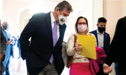  ?? Photograph: Michael Reynolds/EPA ?? Joe Manchin and Kyrsten Sinema walk together to the Senate chamber.