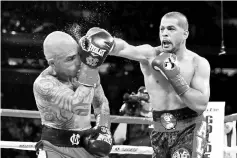  ??  ?? Sadaam Ali punches Miguel Cotto during their Junior Middleweig­ht bout at Madison Square Garden on December 02, 2017 in New York City. - AFP photo