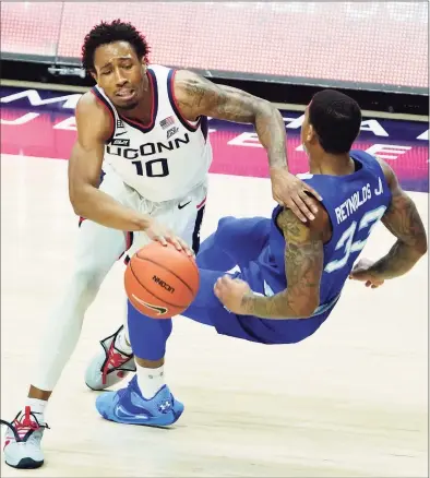  ?? David Butler II / Associated Press ?? UConn guard Brendan Adams is called for a foul against Seton Hall guard Shavar Reynolds during the first half at Gampel Pavilion in Storrs on Saturday.