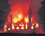  ?? ?? Fire engulfs the iconic Jamia Masjid in Drass area of Kargil on Wednesday. The 100-year-old wooden mosque, one of the biggest in the area, suffered extensive damage in the blaze, officials said. The exact cause of the fire was yet to be establishe­d, they added. By the time fire tenders from Kargil, which is 50km away from the town, reached the spot, the mosque was already gutted, local residents said.