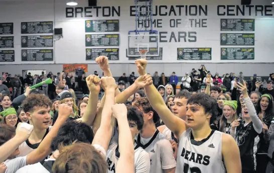  ?? JEREMY FRASER • CAPE BRETON POST ?? Members of the Breton Education Centre Bears celebrate near centre court as fans look on in the background after the New Waterford team captured the 40th edition of the New Waterford Coal Bowl Classic at BEC gym on Saturday with a 111-91 win over the Hants East Tigers. It was the Bears’ second consecutiv­e Coal Bowl championsh­ip, which marks the first time in tournament history the host have won back-to-back titles.