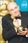  ?? AFP/Getty Images file photo ?? Director Stanley Donen in 1998 with his Oscar for Lifetime Achievemen­t at the 70th Annual Academy Awards in Los Angeles.