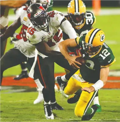  ?? MIKE EHRMANN / GETTY IMAGES FILES ?? Packers QB Aaron Rodgers gets sacked by Tampa Bay in their Oct. 18 game. On the day, Rodgers was blitzed 18 times,
pressured 12 times, hurried into throwing early once, hit seven times and sacked four times.