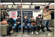  ?? DU LIANYI / CHINA DAILY ?? Right: Passengers on the Beijing subway browse sites on their mobiles.