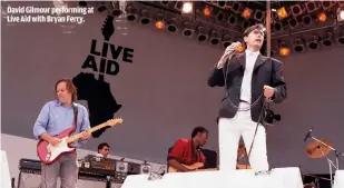  ??  ?? DAVID GILMOUR PERFORMING AT LIVE AID WITH BRYAN FERRY.