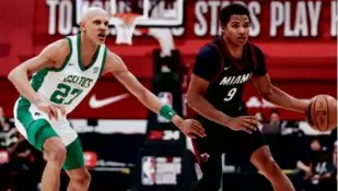  ?? MADELINE CARTER/LAS VEGAS REVIEW-JOURNAL VIA AP ?? Second-round pick Jordan Walsh (left) had a team-high 18 points in the Celtics’ opener, a 99-88 loss to the Heat.