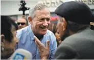  ?? Thomas Coex / AFP / Getty Images ?? Benny Gantz meets with voters during a campaign stop Feb. 1 in the city of Rishon Letzion.