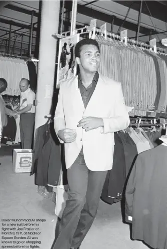  ??  ?? Boxer Muhammad Ali shops for a new suit before his fight with Joe Frazier on March 8, 1971, at Madison Square Garden. Ali was known to go on shopping sprees before his fights.