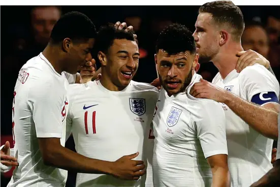  ??  ?? England’s dreaming: Manchester United’s classy star Jesse Lingard is mobbed by his jubilant team-mates after netting winner