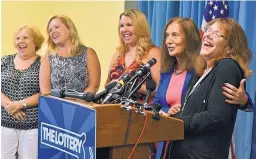  ?? JOSH REYNOLDS/ASSOCIATED PRESS ?? Mavis Wanczyk, right, of Chicopee, Mass., laughs next to state treasurer Deb Goldberg during a news conference where she claimed the Powerball prize Thursday.