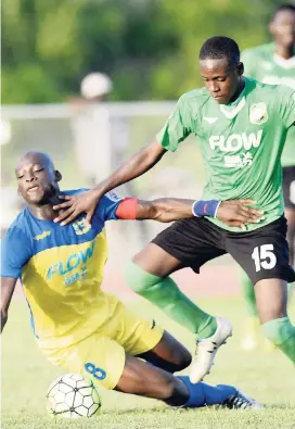  ?? JERMAINE BARNABY/FREELANCE PHOTOGRAPH­ER ?? Hydel’s Maleek Campbell (left) makes a sliding tackle on Calabar High’s Javone Francis during their ISSA-FLOW Manning Cup football clash on Monday at Calabar. The game ended 2-2.