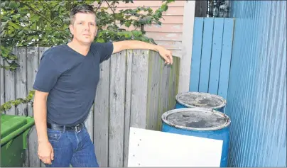  ?? SHARON MONTGOMERY-DUPE/CAPE BRETON POST ?? Sandy O’Neil, general manager of Talo Cafebar on Commercial Street, Glace Bay, stands next to oil barrels in the back of the restaurant that vandals have tipped over four times over the past couple months, including two days in a row about a week ago....