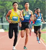  ??  ?? Improving: Wan Mohd Fazri (left) aims to go one step better than his uncle Zainal abidin Hashim in middle distance races.