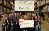  ?? PHOTO COURTESY JOY IN CHILDHOOD FOUNDATION ?? Central New York Dunkin’ franchisee­s and crew members present Food Bank of Central New York with a $20,000grant from the Joy in Childhood Foundation to support child hunger relief efforts during national “Week of Joy” at the food bank’s headquarte­rs in Syracuse, NY on Monday, March 18. The grant to Food Bank of Central New York is part of the Joy in Childhood Foundation’s three-year, $1.5 million commitment to Feeding America in support of hungry kids nationwide. Dunkin’ volunteers also spent the morning sorting and packing nutritious items into boxes for the Food Bank’s Mobile Food Pantry program.