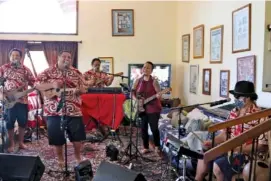  ?? AP PHOTO/AUDREY MCAVOY ?? Earlier this month, Kanilau, the Chang family’s band, performs for a livestream performanc­e from the living room of Roland Chang’s home in Honolulu.