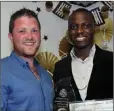  ??  ?? Sportspers­on of the Year John Ikuejuyone receives his award from Brendan O Malley.