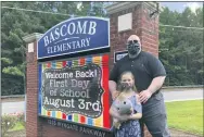  ?? JEFF AMY—ASSOCIATED PRESS ?? John Barrett and his daughter Autumn pose for photos outside Bascomb Elementary School in Woodstock, Ga., Thursday, July 23, 2020. Barrett says he will educate his daughter virtually and keep her out of in-person classes in Cherokee County schools, even though he’s worried she will fall behind on her special education plans, because of concerns about COVID-19’s spread. Cherokee County, near Atlanta, is one of many districts nationwide that gave parents a choice between in-person and all-online classes this fall.