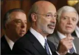  ?? MATT ROURKE – ASSOCIATED PRESS FILE PHOTO ?? Pennsylvan­ia Gov. Tom Wolf, center, speaks as state House Minority Leader Rep. Frank Dermody, right, D-Allegheny, and state Rep. Joe Markosek, left, D-Allegheny, look on.