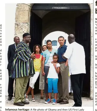  ?? — AFP ?? Infamous heritage: A file photo of Obama and then US First Lady Michelle Obama with their daughters Sasha and Malia standing at the entrance of the ‘Door of No Return’ during a guided tour in Cape Coast Castle, a former slavery outpost in Ghana.