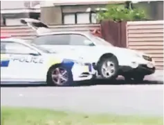  ??  ?? A police car blocks the car of a suspect following shootings at two mosques in Christchur­ch.