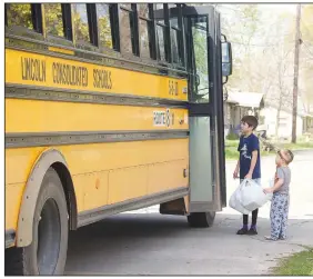  ??  ?? Lincoln School District delivered meals to its students and younger siblings during spring break. On Thursday, bus drivers and helpers delivered Thursday’s lunch, Friday’s breakfast and Friday’s lunch throughout the district.
(NWA Democrat-Gazette/Lynn Kutter)