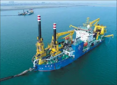  ?? XINHUA ?? Tian Kun Hao, owned by CCCC Tianjin Dredging Corp Ltd, carries out dredging operation in the offshore waters off the Chinese mainland. It is the largest heavy-duty self-propelled winch suction vessel in Asia.