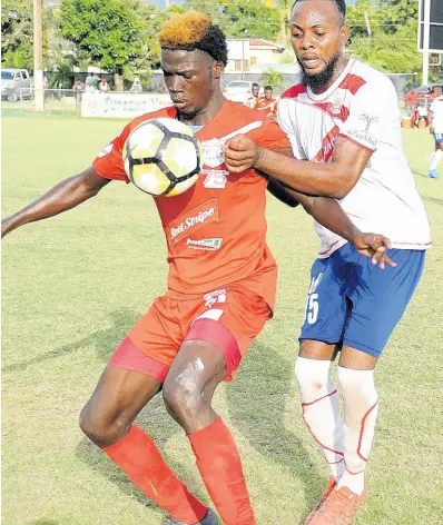  ?? FILE ?? In this file photo from March 2017, Shamar Nicholson (left), then of Boys’ Town, takes control of the ball while under pressure from Maverley Hughenden’s Andrew Whyte during a Red Stripe Premier League match at the Barbican Field.