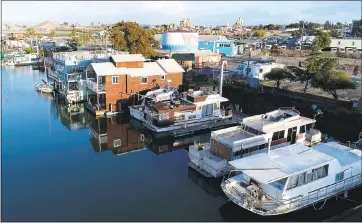  ?? JANE TYSKA — STAFF PHOTOGRAPH­ER ?? Boats and floating homes are seen in this drone view of Docktown Marina, home of the Peninsula Yacht Club in Redwood City. Some residents, known as “bitter-enders,” are fight evictions in court.