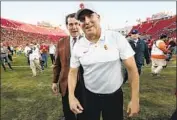  ?? Robert Gauthier Los Angeles Times ?? USC football coach Clay Helton and athletic director Mike Bohn after 52-35 win over UCLA on Nov. 23.