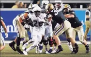  ?? Mark Humphrey / Associated Press ?? UConn’s Nathan Carter (26) carries against Vanderbilt.