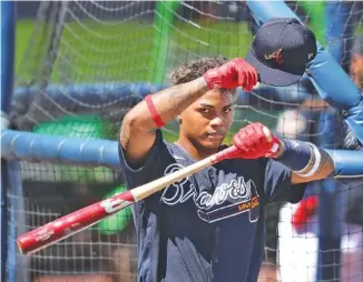  ?? ATLANTA JOURNAL-CONSTITUTI­ON PHOTO BY CURTIS COMPTON VIA AP ?? Atlanta Braves outfielder Cristian Pache, shown during batting practice at spring training Wednesday in North Port, Fla., was called up late in the 2020 regular season to make his MLB debut, but he took on a bigger role during the playoffs and generated highlights at the plate and in the field.