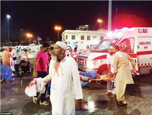  ??  ??  Rescue workers attending to victims after a crane fell on the Grand Mosque in Mecca killing 87 worshipper­s on Friday.PhotoDaily Mail