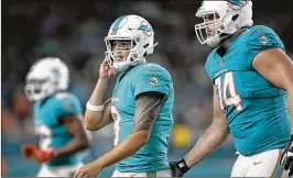  ?? ALLEN EYESTONE / THE PALM BEACH POST ?? Dolphins quarterbac­k David Fales leaves the field after throwing an intercepti­on Saturday against the Ravens.