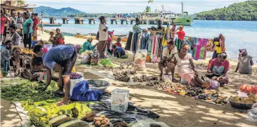  ?? PHOTOS: TNS ?? Community . . . Market day on Marapa Island brings regional families together to buy, sell and visit.