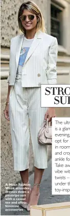  ??  ?? A Milan Fashion Week attendee dresses down a pinstripe suit with a casual tee and ultrafemin­ine accessorie­s