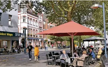  ?? NGZ-FOTO: LOTHAR BERNS ?? Wie das Wetter auch ist: Unter den Schirmen der Lokale am Markt sitzen Gäste immer gut. Mehr dieser außengastr­onomischen Konzepte, speziell bei Restaurant­s, würde die Innenstadt weiter beleben.