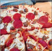  ?? PHOTO BY TIM COTTER ?? Mama Cozzi’s rising crust three-meat pizza