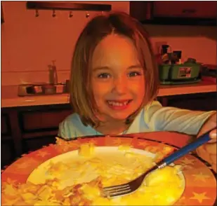  ??  ?? Author’s daughter, Kylie 7, partaking in the consumptio­n of a good luck pork and sauerkraut meal.