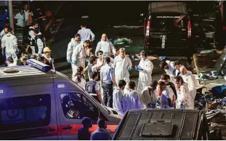  ?? Ozan Kose / AFP / Getty Images ?? Forensic police work the explosion site at Ataturk airport after attacks by suicide bombers.