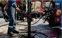  ?? — Reuters ?? A drilling crew uses a machine on an oil rig near texas.