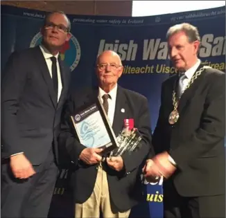  ??  ?? Minister Simon Coveney, Jack Barry, with his National Volunteer of the Year award, and IWS chair Martin O’Sullivan.