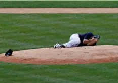  ?? Photo/Adam Hunger
AP ?? New York Yankees pitcher Masahiro Tanaka lies on the field after being hit by a ball off the bat of Yankees Giancarlo Stanton during a baseball a workout at Yankee Stadium in New York, on Saturday.